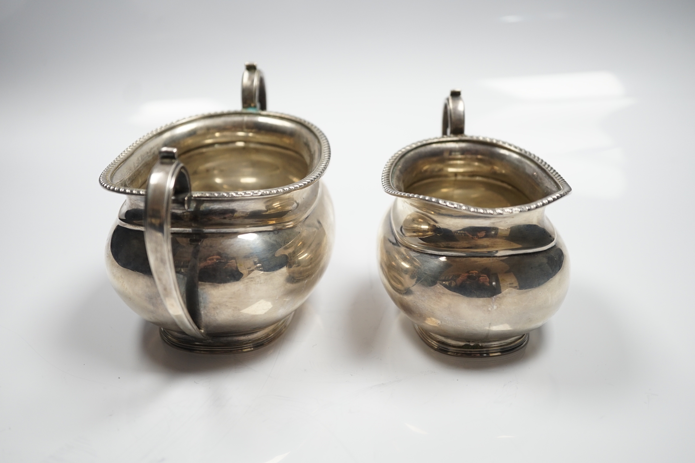 A George V silver oval cream jug and sugar bowl, Sebastian Garrard, London, 1927, 14.8oz.